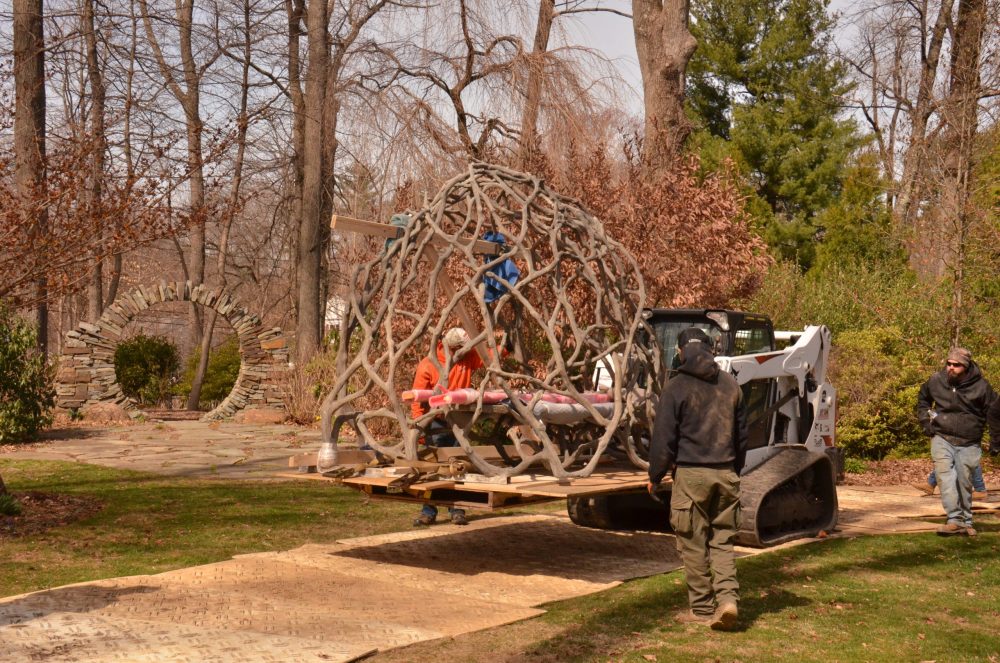 the faux bois sculpture passes by the stone moon gate