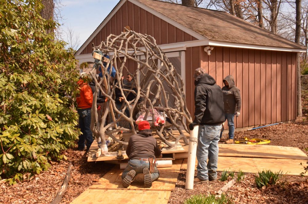 moving faux bois sculpture past shed
