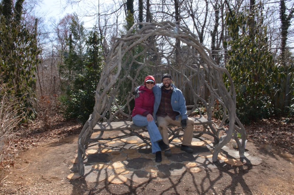 faux bois sculpture in place with man and woman sitting on bench