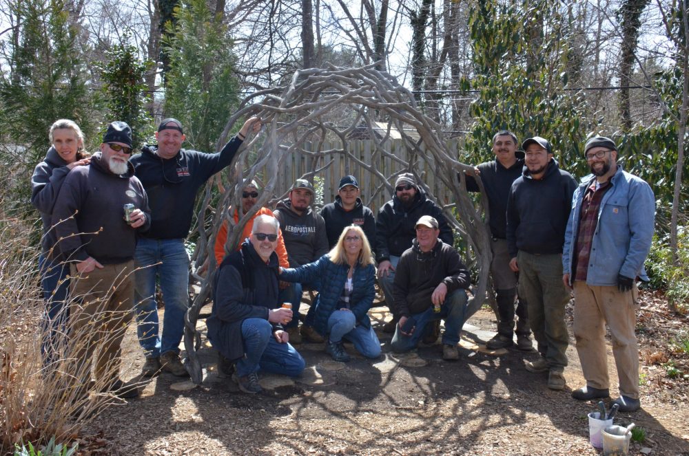 group of people around the sculpture they moved into place