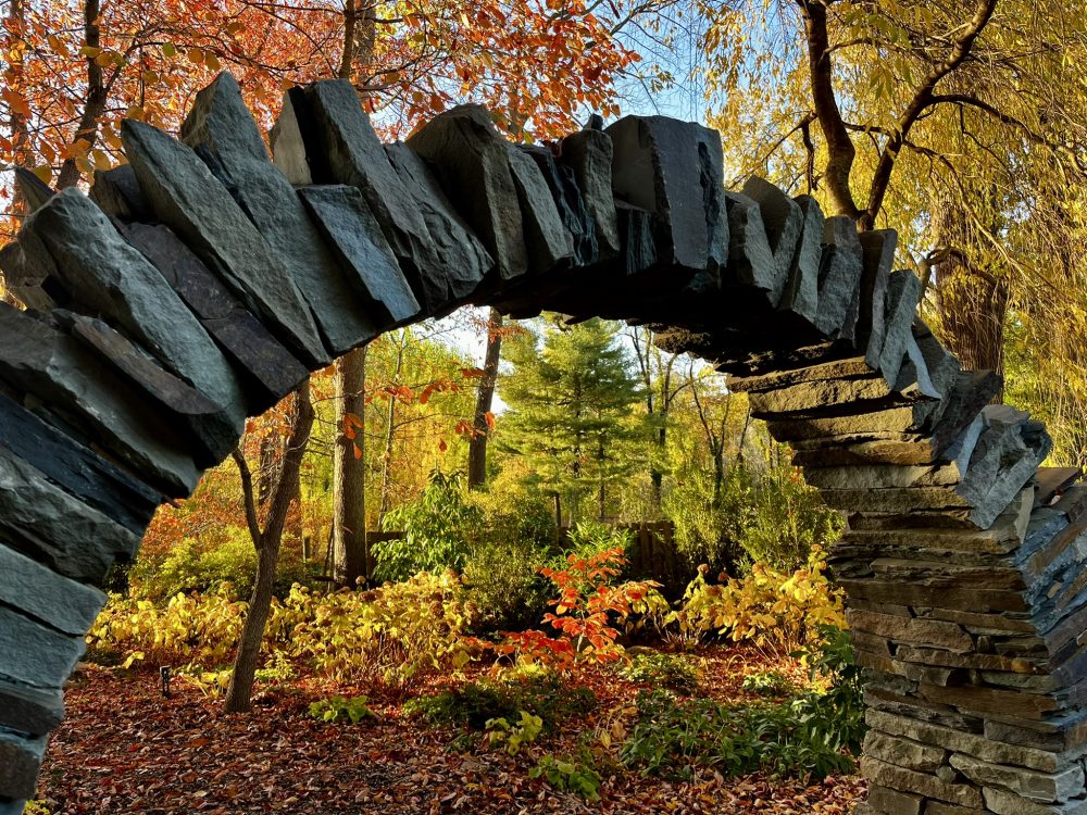 picture of fall landscape through stone moon gate