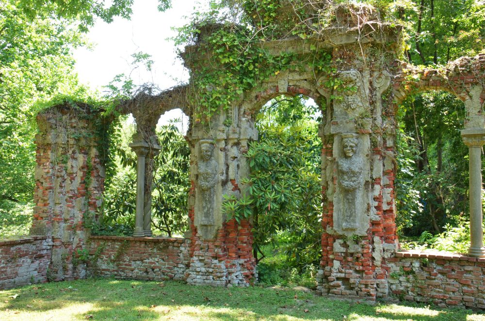 brick columns in a ruin garden covered in ivy