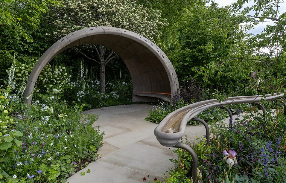 arched sitting area and rill with water around paved walkway